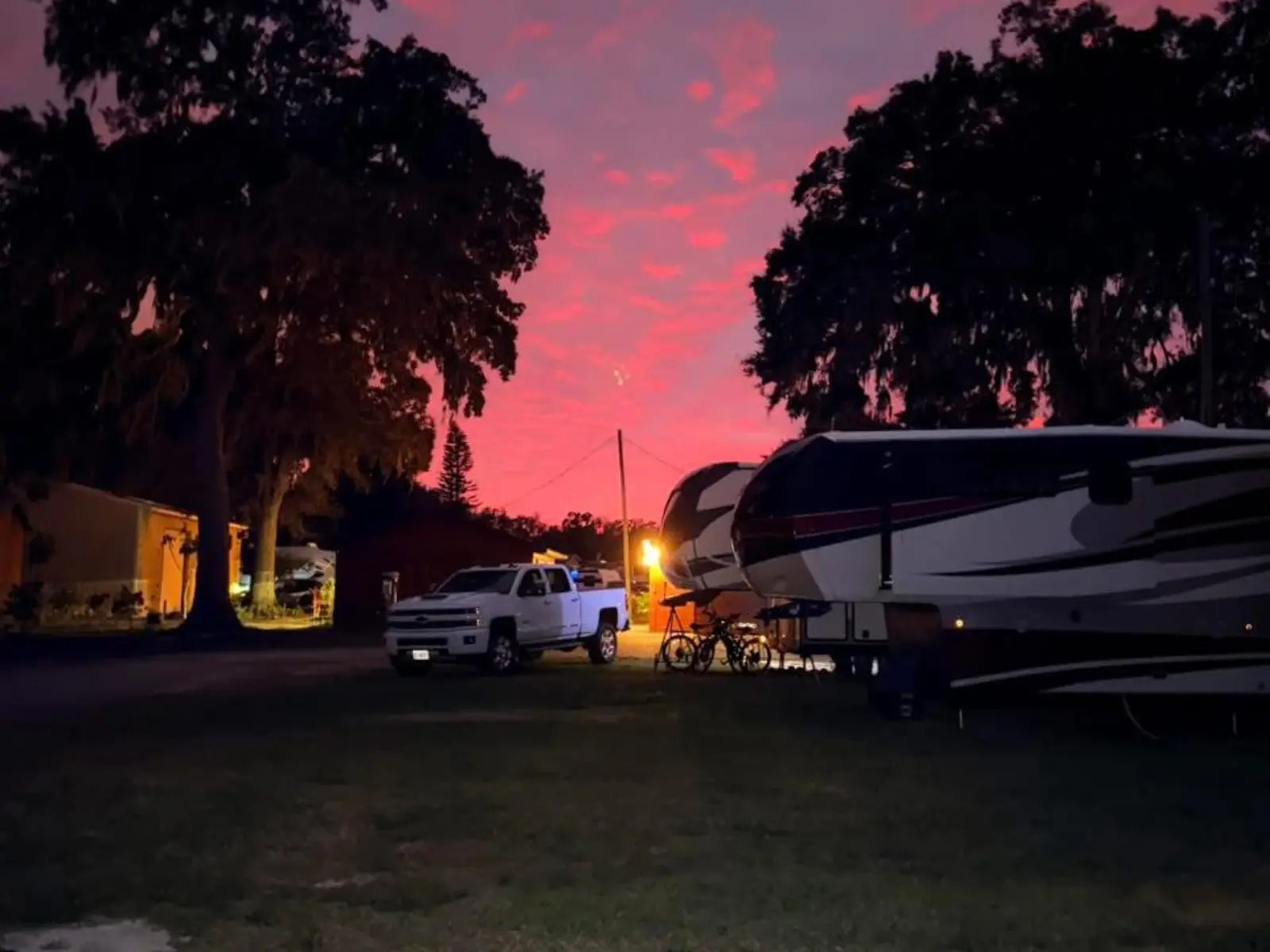 Pink Florida sunset over RV sites at Endless Summer Campground